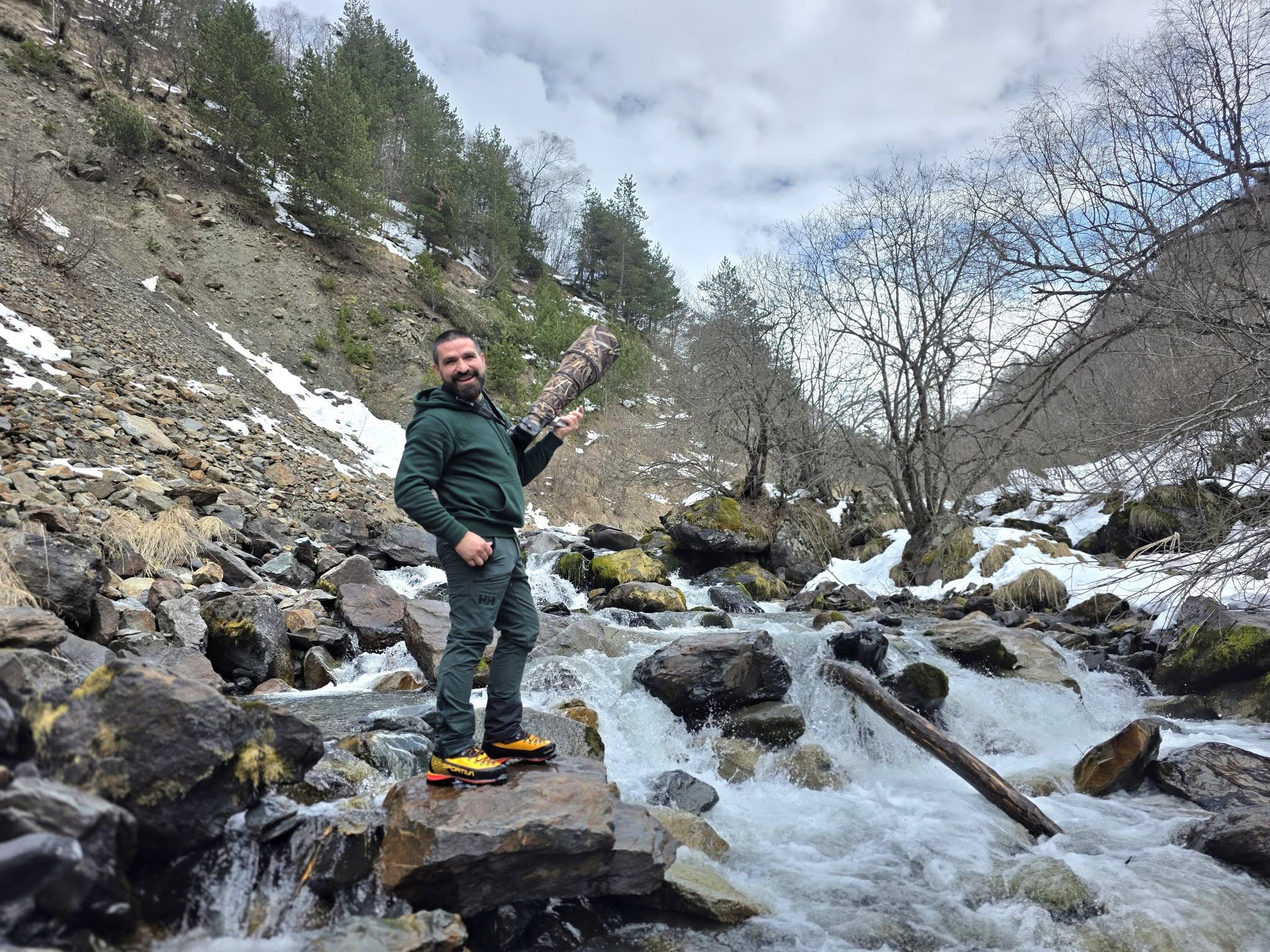 Levan Kobalia with his camera beside a mountain stream
